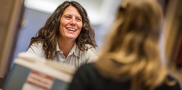 Smiling female office staff member and customer