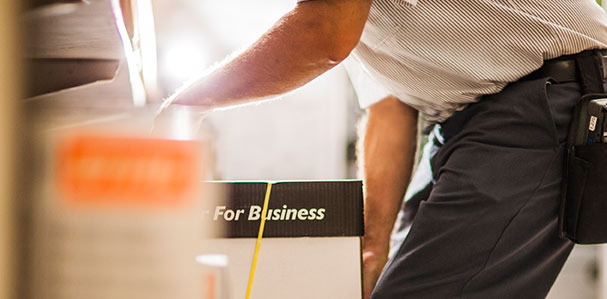 worker lifting paper carton
